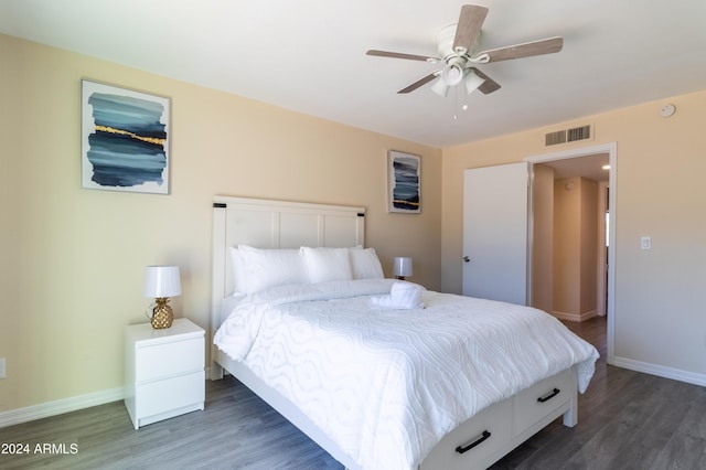 bedroom with ceiling fan and dark wood-type flooring