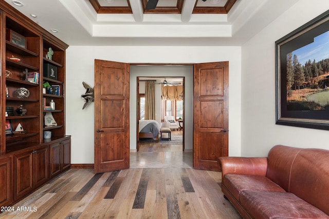 interior space featuring coffered ceiling, wood-type flooring, and beamed ceiling