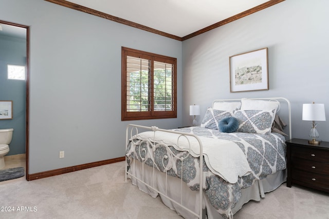 carpeted bedroom with ensuite bathroom and crown molding