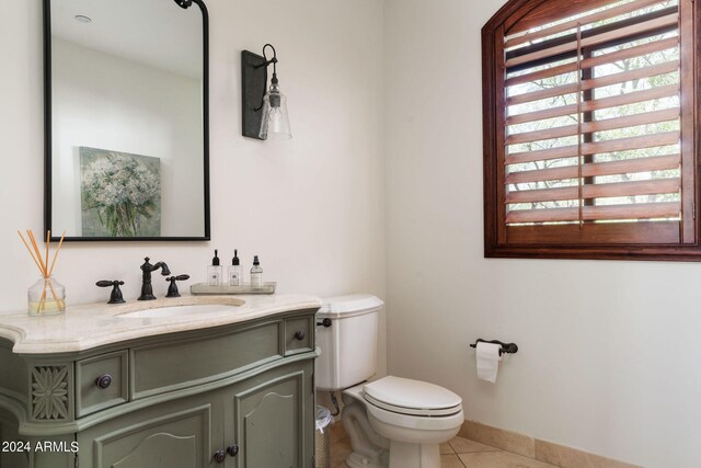 bathroom with vanity, toilet, and tile patterned floors