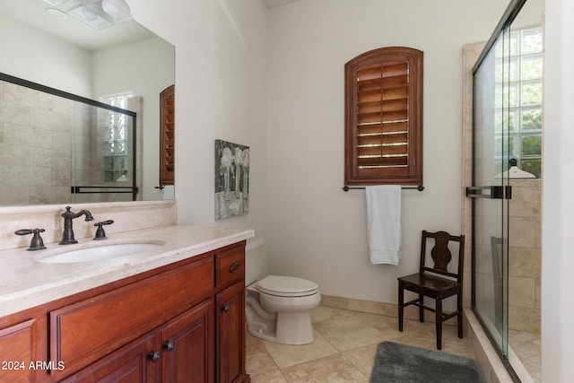 bathroom with vanity, an enclosed shower, toilet, and tile patterned floors