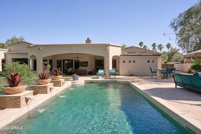 back of property featuring a fenced in pool, a patio area, pool water feature, and ceiling fan