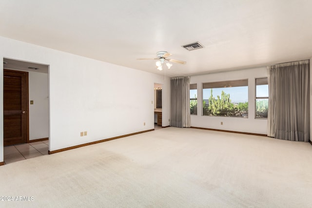 unfurnished room with light carpet and ceiling fan