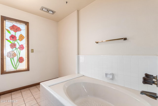 bathroom featuring tile patterned flooring and tiled bath