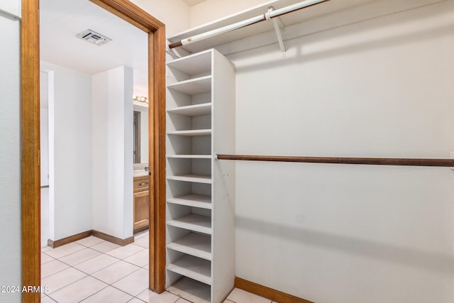 spacious closet featuring light tile patterned floors