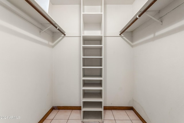 spacious closet featuring light tile patterned floors