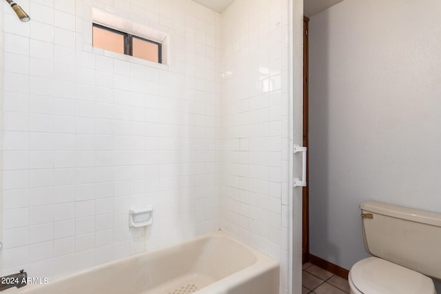 bathroom with toilet, tile patterned floors, and tiled shower / bath