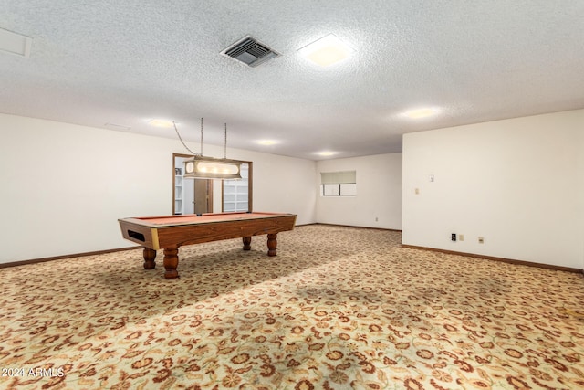 recreation room with pool table, a textured ceiling, and carpet flooring