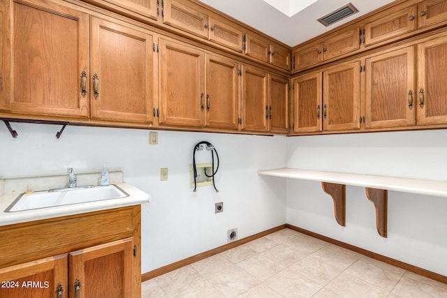 washroom featuring cabinets, sink, and electric dryer hookup