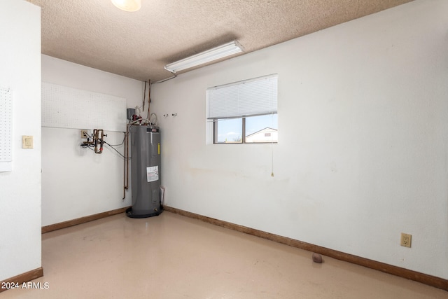 interior space featuring water heater and a textured ceiling