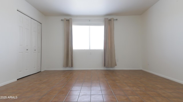 3556 W Augusta Ave, Phoenix, AZ 85051 - unfurnished bedroom with tile patterned floors, a closet, and baseboards