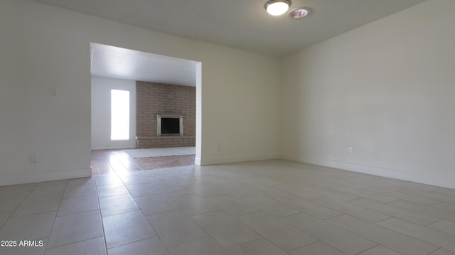3556 W Augusta Ave, Phoenix, AZ 85051 - unfurnished living room featuring light tile patterned floors, a fireplace, and baseboards