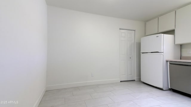 3556 W Augusta Ave, Phoenix, AZ 85051 - kitchen with freestanding refrigerator, stainless steel dishwasher, baseboards, and light countertops