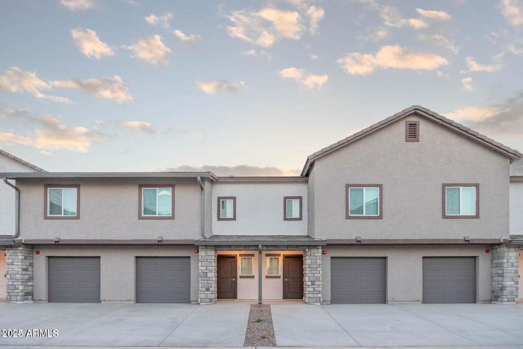 townhome / multi-family property featuring a garage