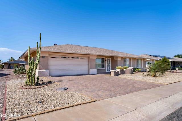 ranch-style home featuring a garage