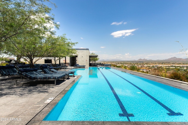 view of pool featuring a mountain view and a patio