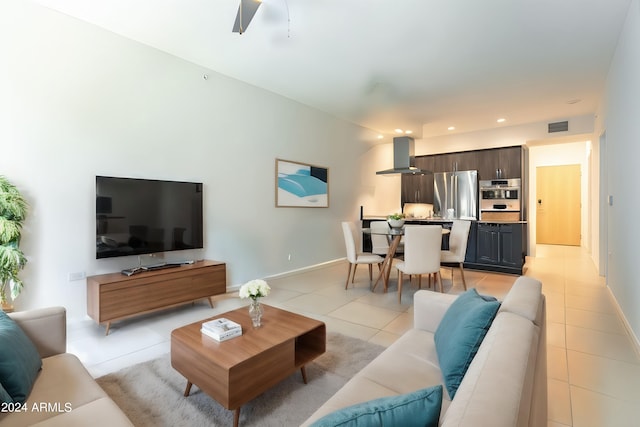 living room with ceiling fan and light tile patterned floors