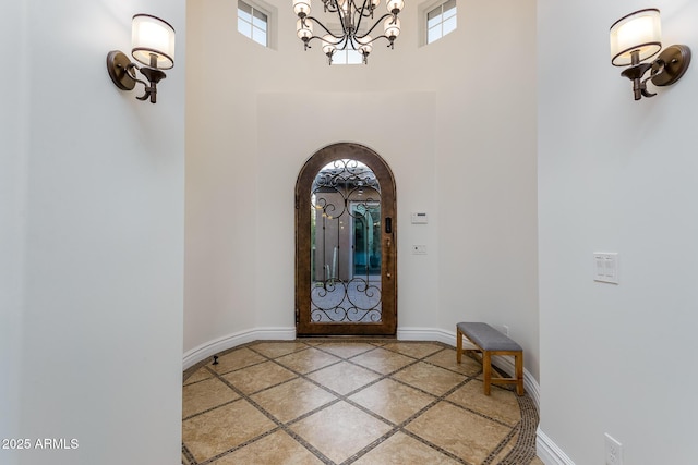35443 N 87th Pl, Scottsdale, AZ 85266 - foyer entrance with inlaid floor details, healthy amount of natural light, a towering ceiling, a chandelier, and baseboards
