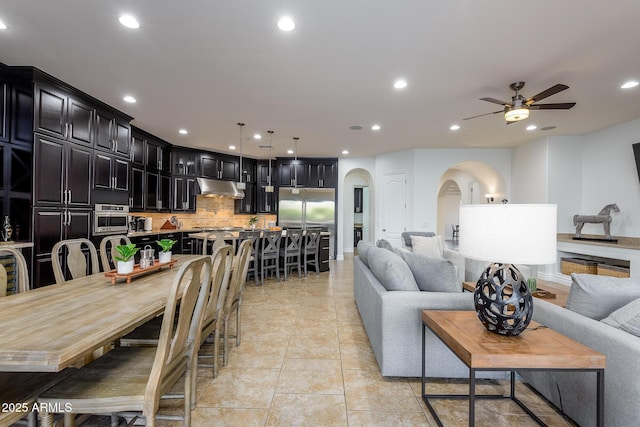 35443 N 87th Pl, Scottsdale, AZ 85266 - living area with arched walkways, ceiling fan, recessed lighting, and light tile patterned floors