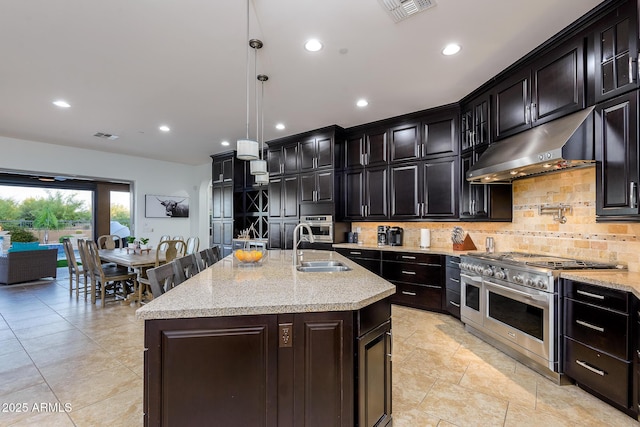 35443 N 87th Pl, Scottsdale, AZ 85266 - kitchen featuring under cabinet range hood, appliances with stainless steel finishes, a sink, backsplash, and light stone countertops