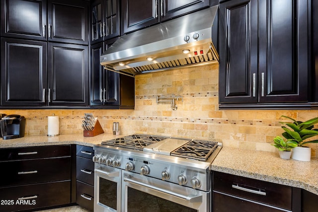 35443 N 87th Pl, Scottsdale, AZ 85266 - kitchen featuring range with two ovens, under cabinet range hood, backsplash, and dark cabinets