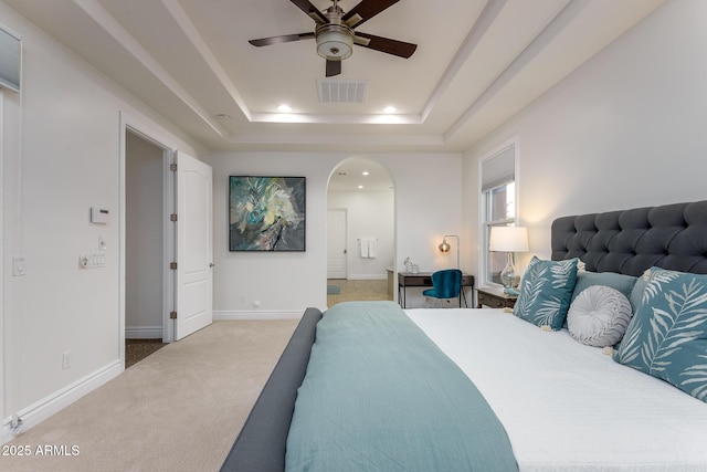 35443 N 87th Pl, Scottsdale, AZ 85266 - carpeted bedroom featuring arched walkways, recessed lighting, a tray ceiling, baseboards, and ensuite bath