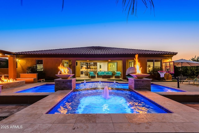 35443 N 87th Pl, Scottsdale, AZ 85266 - pool at dusk featuring an outdoor living space with a fire pit, an in-ground hot tub, a patio, and an outdoor pool