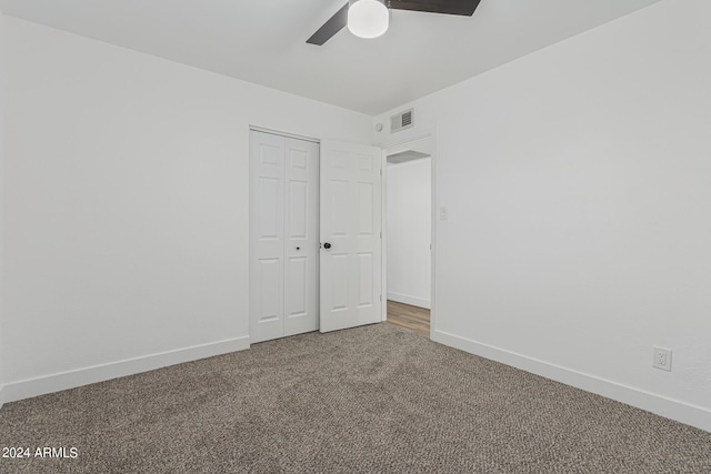 interior space featuring ceiling fan and carpet