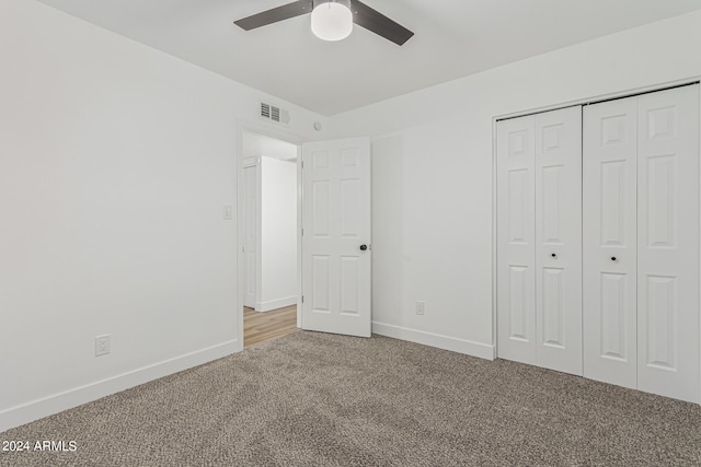 unfurnished bedroom featuring a closet, ceiling fan, and light carpet