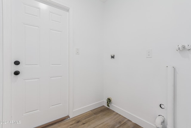 laundry room with light hardwood / wood-style floors, electric dryer hookup, and gas dryer hookup