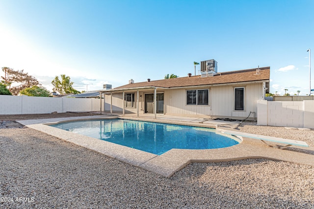 view of pool with a patio area, a diving board, and cooling unit