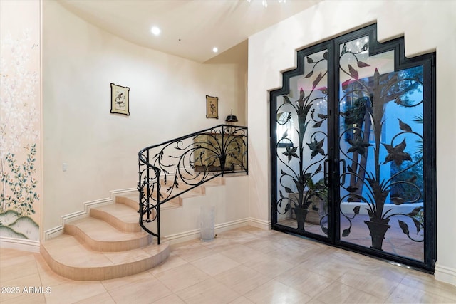 foyer entrance with light tile patterned floors