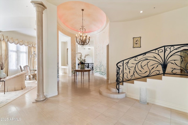 hallway featuring light tile patterned floors, ornate columns, and a chandelier