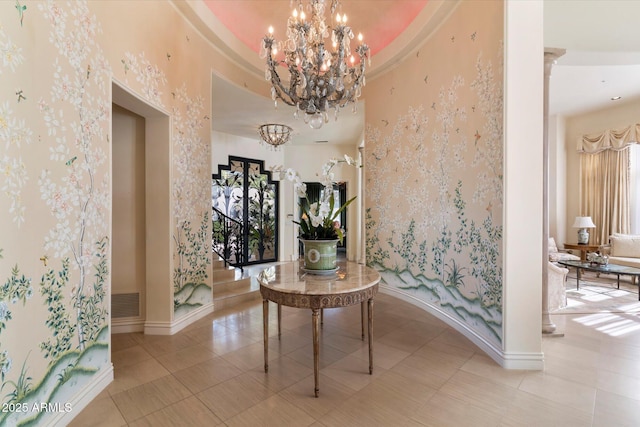 hallway with light tile patterned floors and a notable chandelier