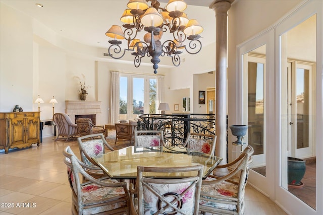 tiled dining space with decorative columns and an inviting chandelier