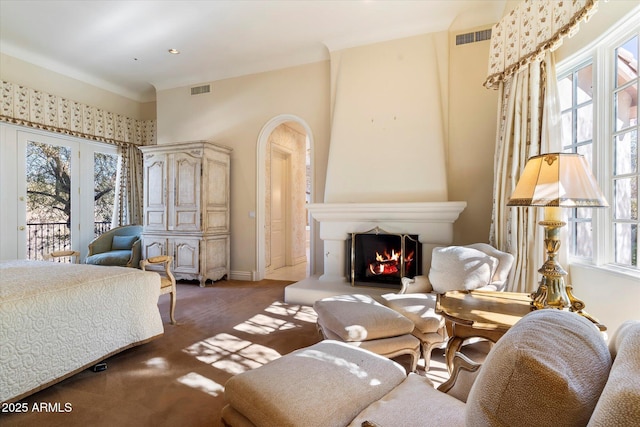 bedroom with access to outside and a fireplace