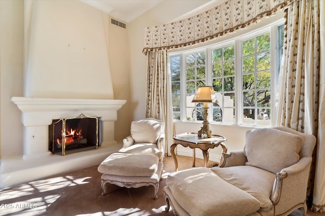 sitting room featuring carpet floors, vaulted ceiling, and a fireplace