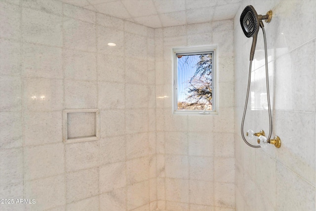 bathroom with a tile shower