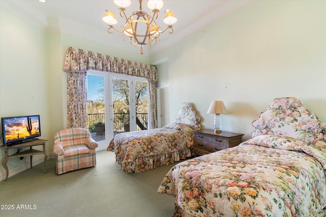 carpeted bedroom featuring access to outside and a chandelier