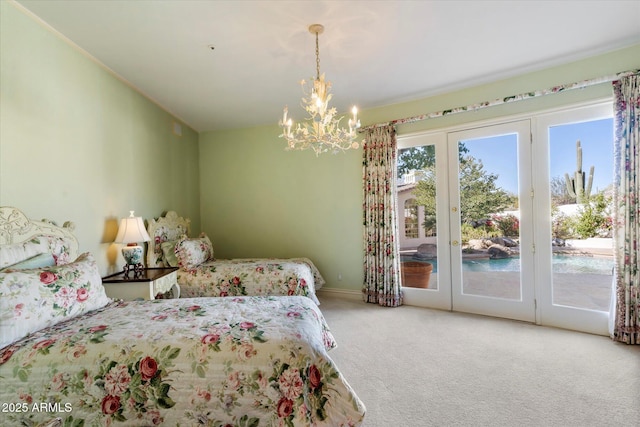 bedroom featuring carpet, lofted ceiling, access to exterior, a notable chandelier, and french doors