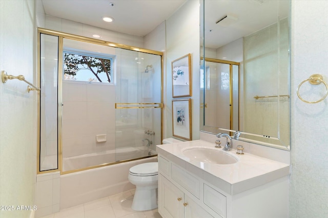 full bathroom with bath / shower combo with glass door, toilet, vanity, and tile patterned flooring