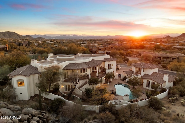 aerial view at dusk featuring a mountain view