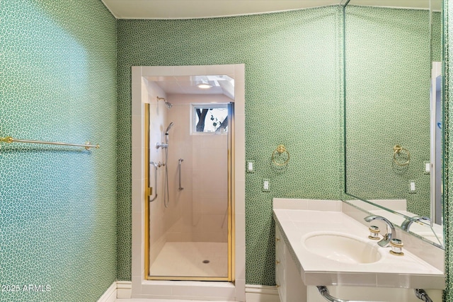 bathroom with a shower with shower door and sink