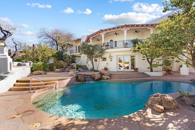 view of pool featuring ceiling fan, a patio area, pool water feature, and french doors