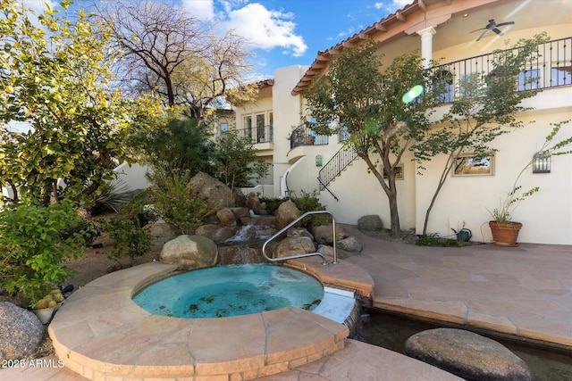 view of swimming pool featuring ceiling fan, a patio, and an in ground hot tub