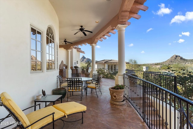 balcony with ceiling fan and a mountain view