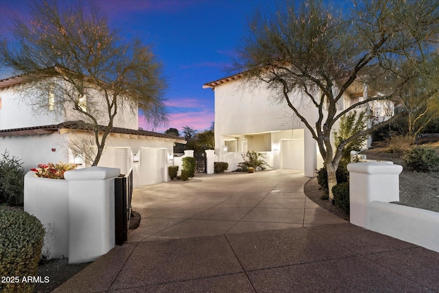 property exterior at dusk with a garage