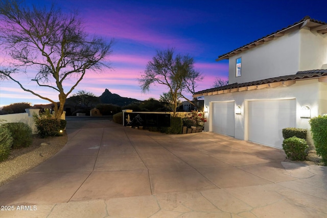 property exterior at dusk featuring a garage