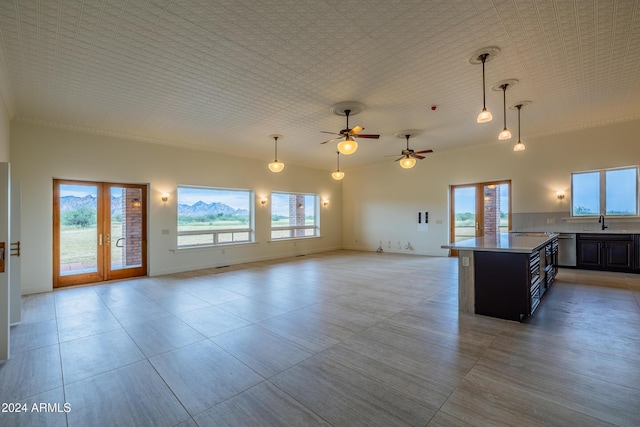 kitchen with a wealth of natural light, ceiling fan, and decorative light fixtures