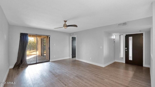 empty room with ceiling fan and hardwood / wood-style floors